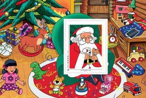 Timbre - Le père Noël et les cadeaux au pied du sapin.